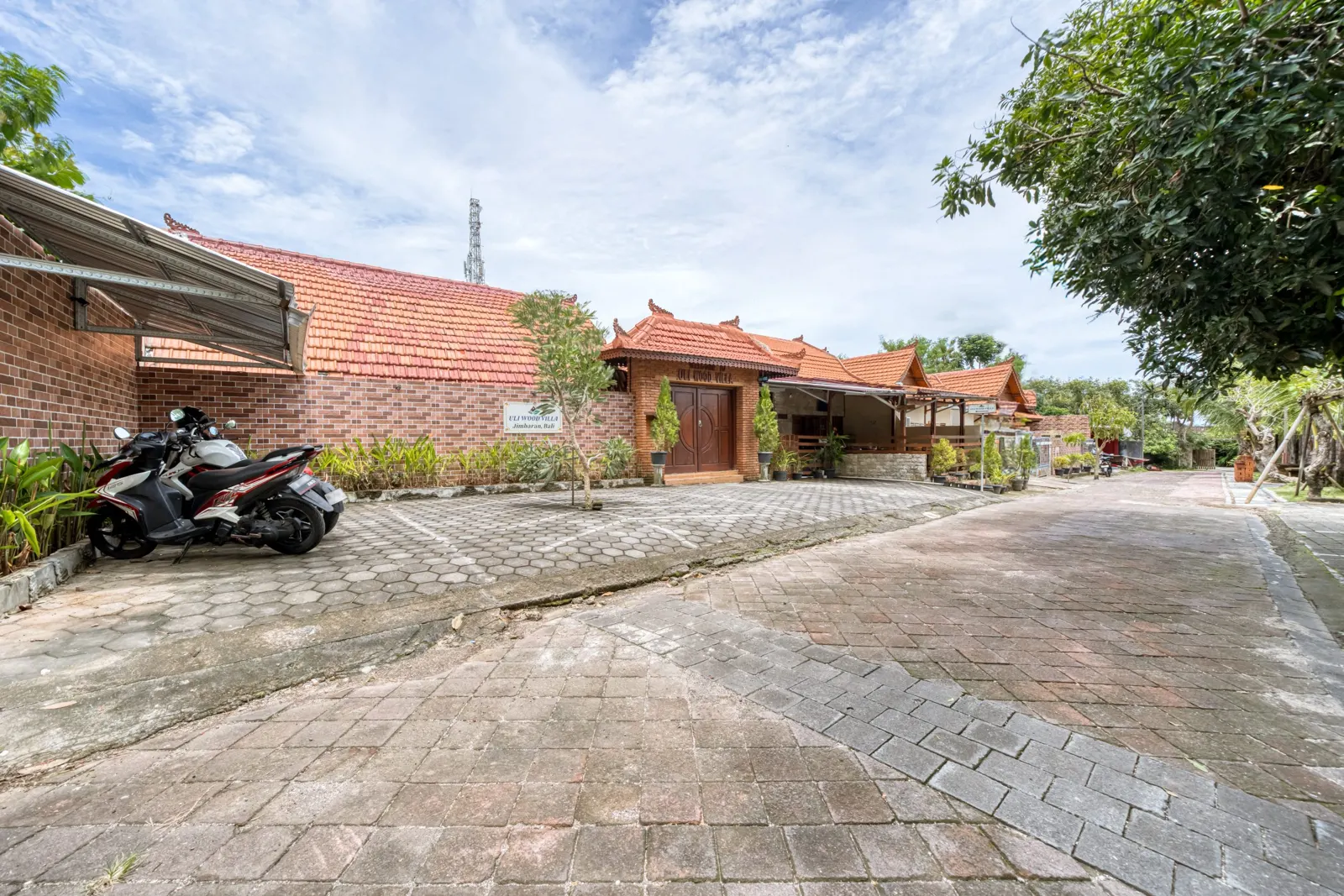 Villa entrance and paved parking area