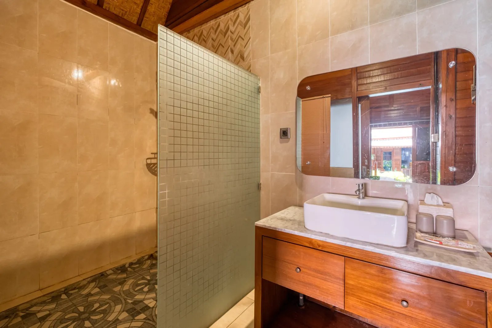 Tiled bathroom with a shower and wooden vanity