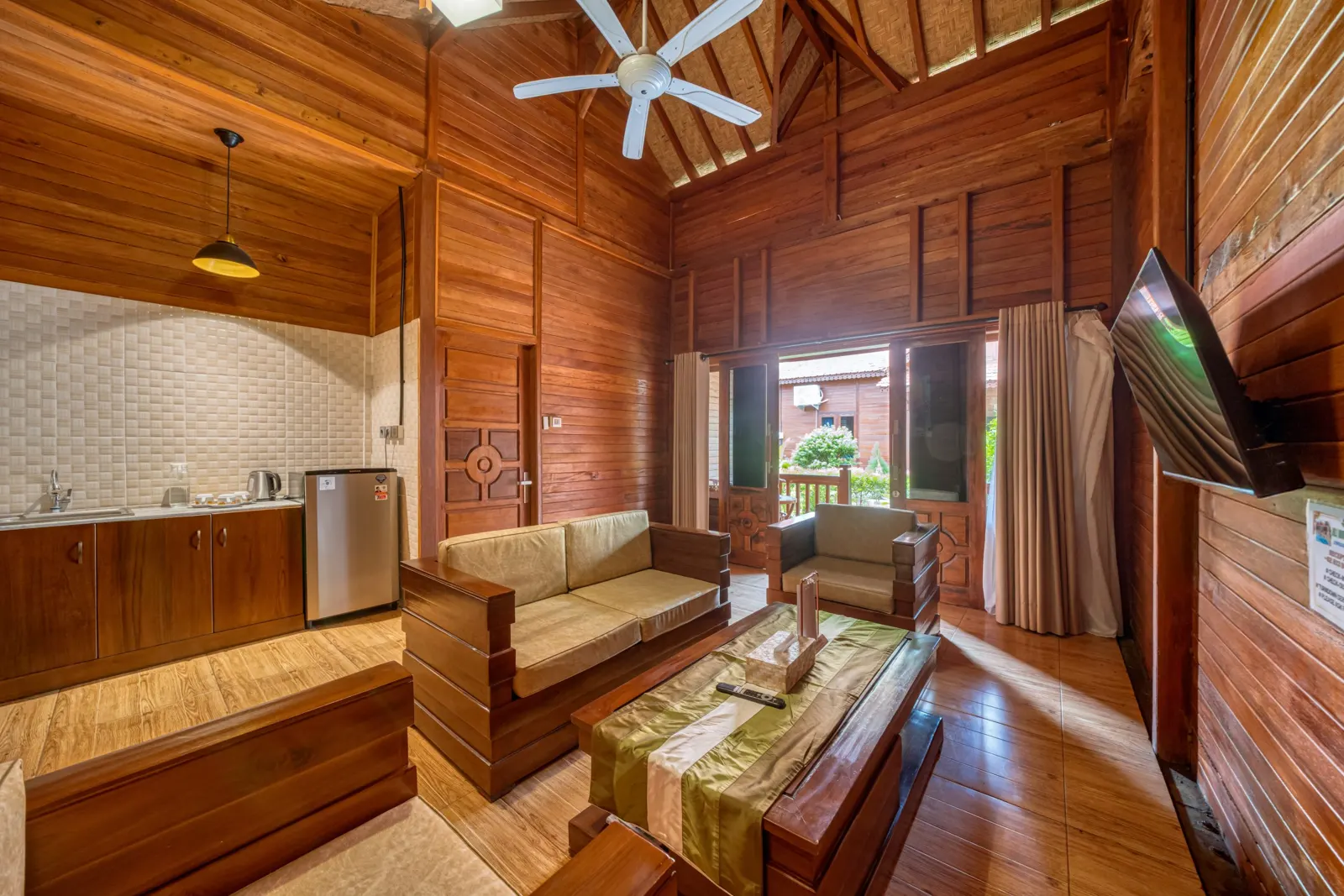 Wooden living room with sofas, a coffee table and kitchenette