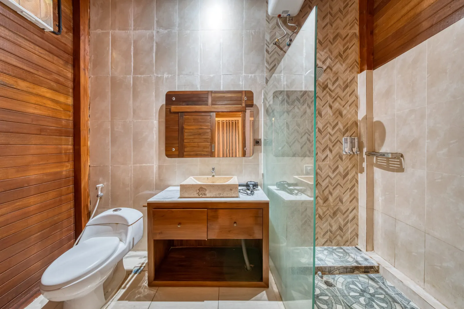 Bathroom vanity beside a glass shower partition