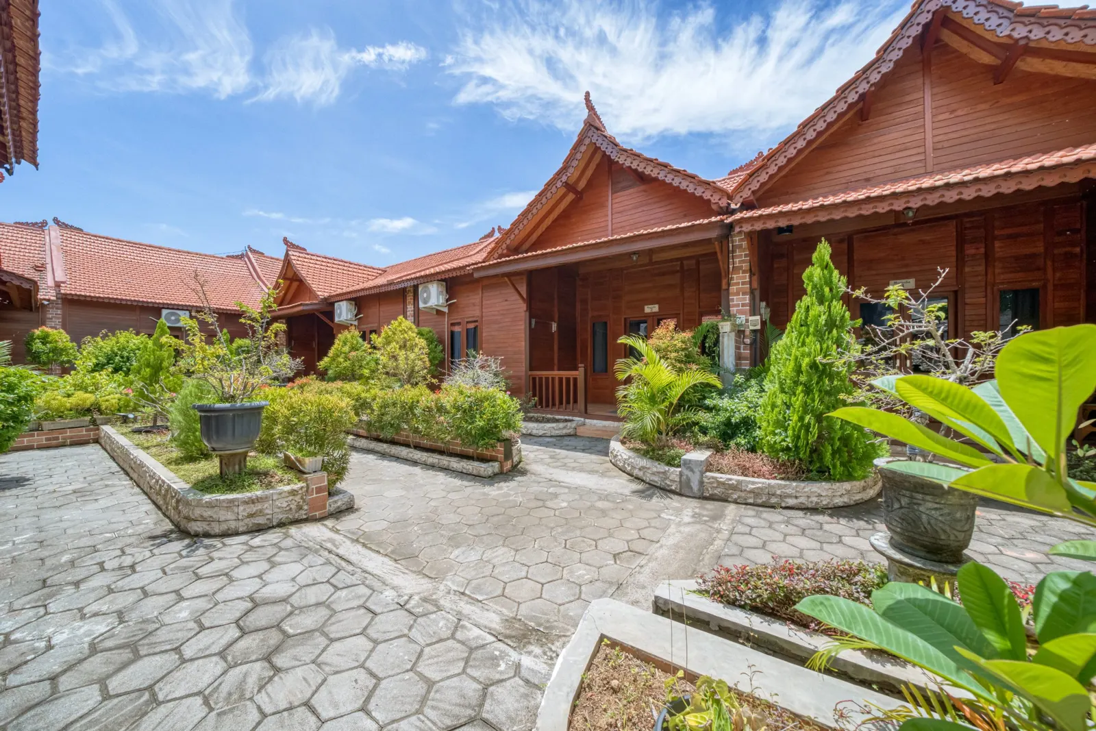 Landscaped courtyard with tropical plants and wooden villas