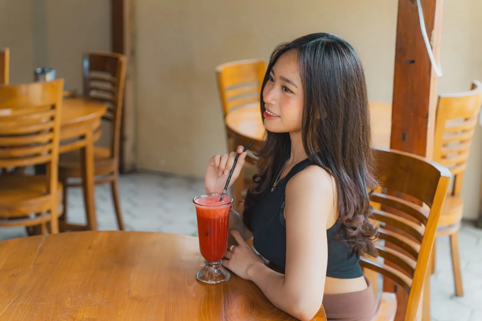 Guest enjoying a drink at the villa dining table