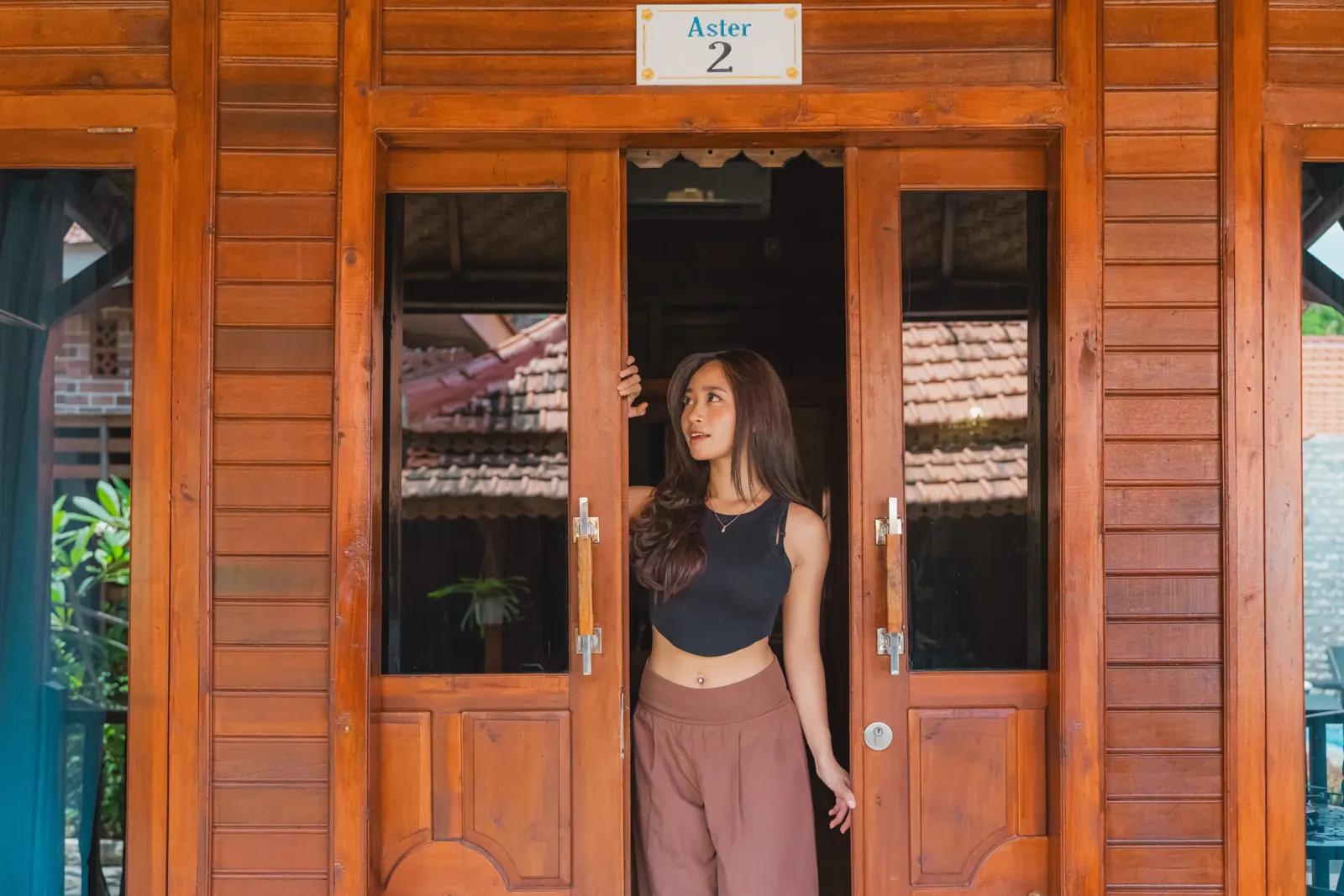 Guest standing in the doorway of a wooden villa
